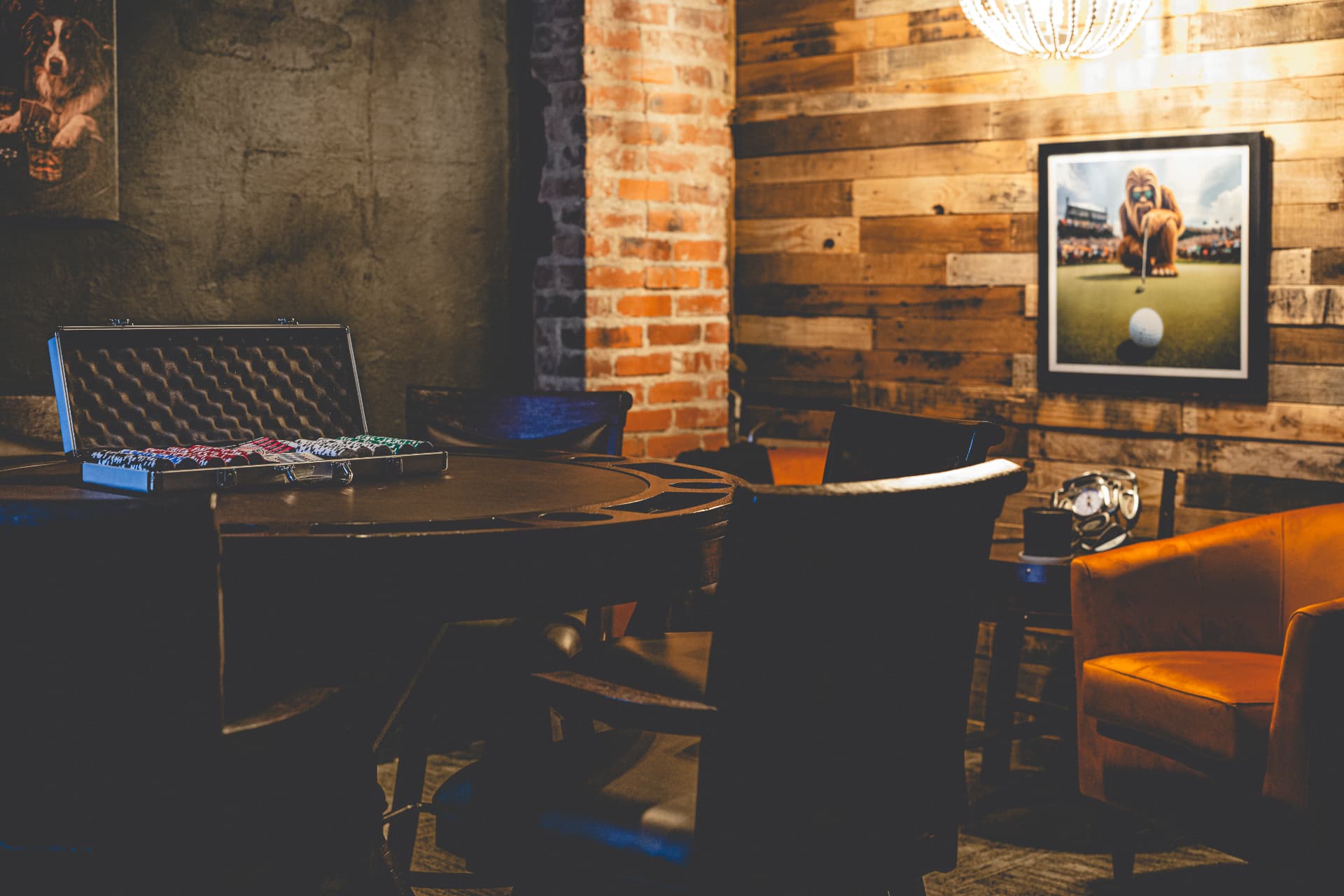 Off Course private Speakeasy poker table with chips, leather chairs, brick and wood walls