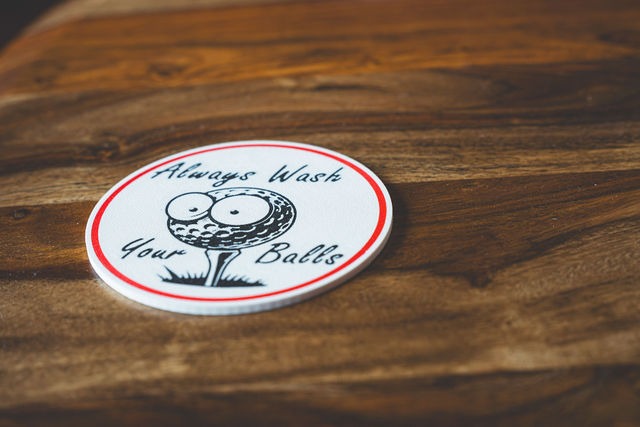 A coaster that reads Always Wash Your Balls