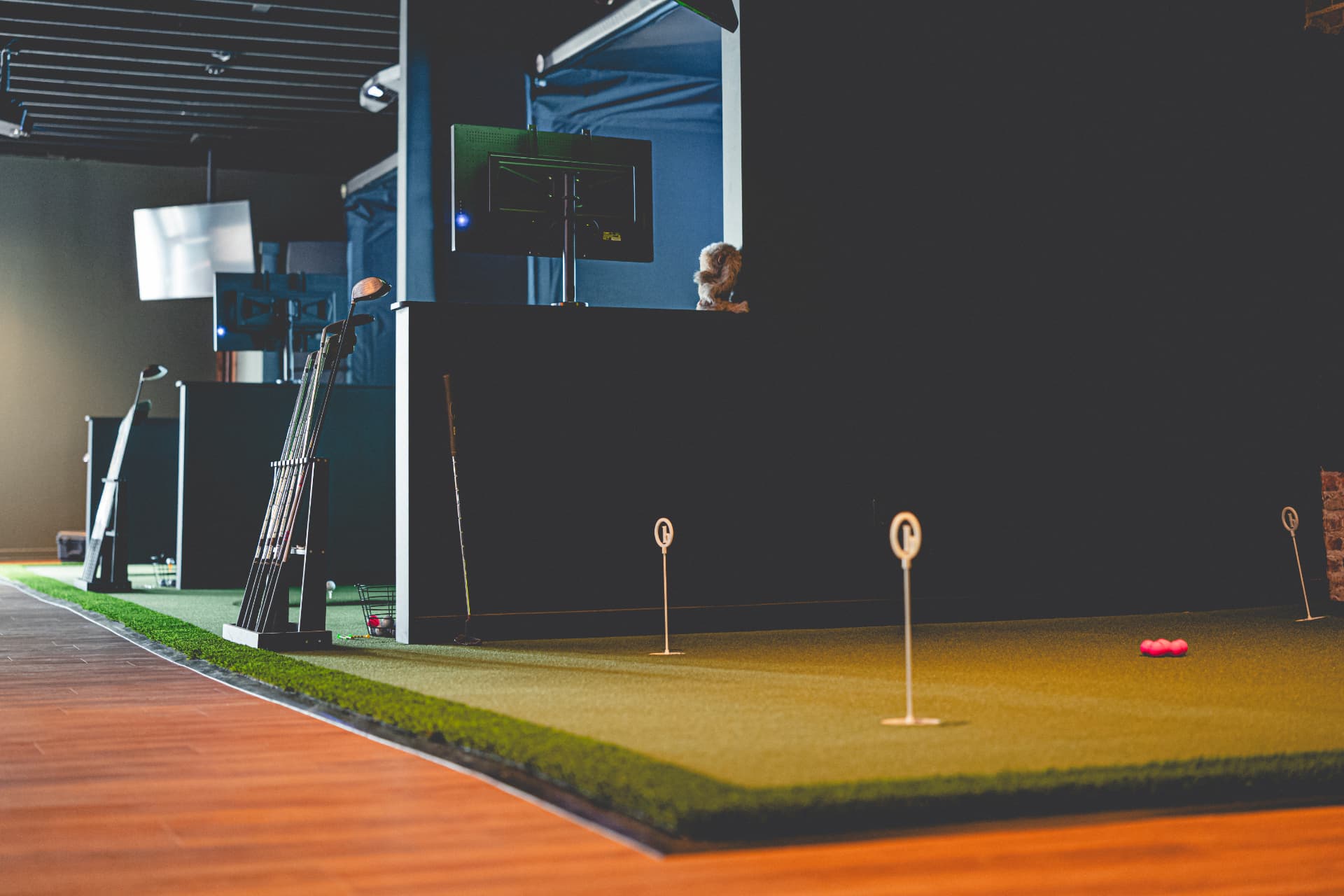 Indoor putting green and simulator bays at Off Course