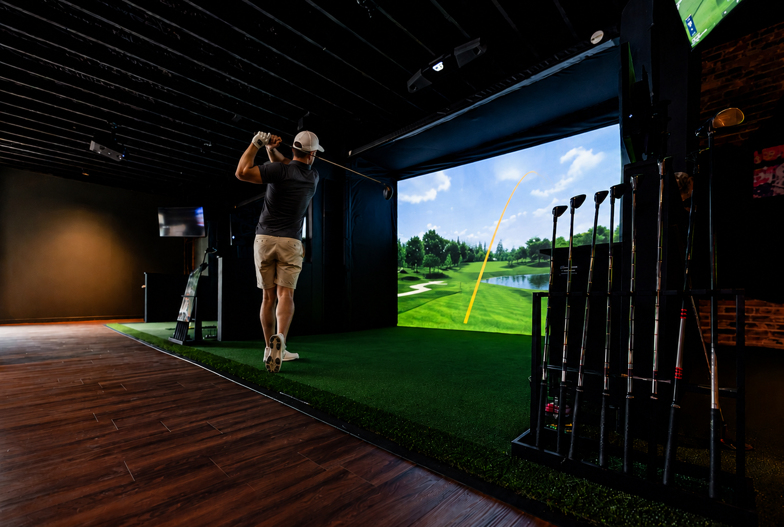 Golfer mid-swing in a simulator bay at Off Course